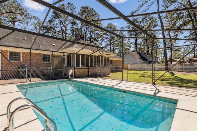 view of pool featuring a fenced in pool, a lawn, a patio area, fence, and a lanai