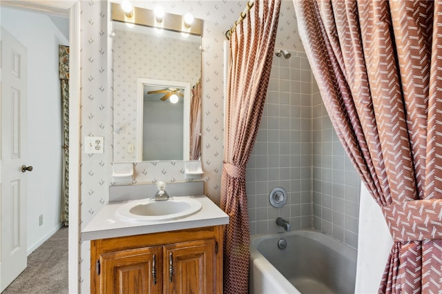 full bath with shower / bath combo with shower curtain, vanity, and wallpapered walls