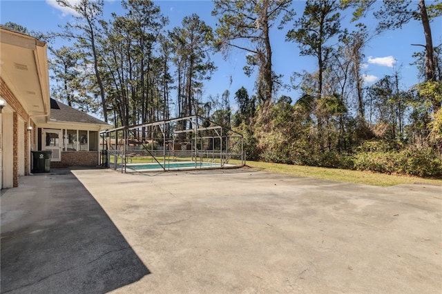 exterior space featuring a lanai and an outdoor pool