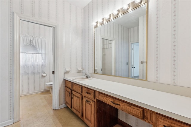 bathroom featuring tile patterned floors, vanity, toilet, and wallpapered walls