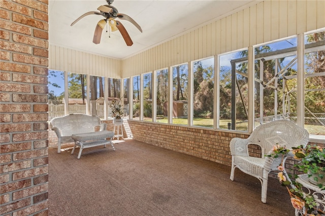 unfurnished sunroom featuring ceiling fan