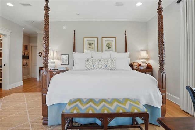 bedroom with visible vents, light wood-style floors, and ornamental molding