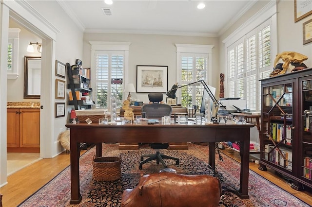 office area featuring visible vents, crown molding, and wood finished floors