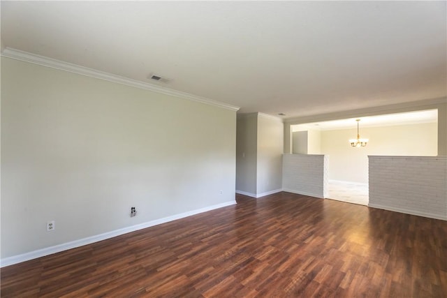 907 Euclid Ave, Waycross, GA 31501 - spare room with a chandelier, ornamental molding, and dark wood finished floors