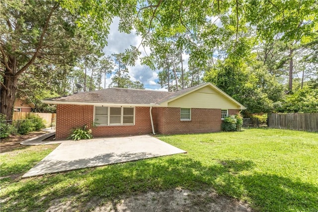 907 Euclid Ave, Waycross, GA 31501 - back of house with a patio, brick siding, and a fenced backyard