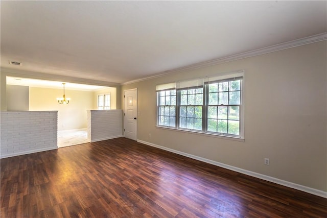 907 Euclid Ave, Waycross, GA 31501 - unfurnished living room with a chandelier, crown molding, plenty of natural light, and dark wood finished floors