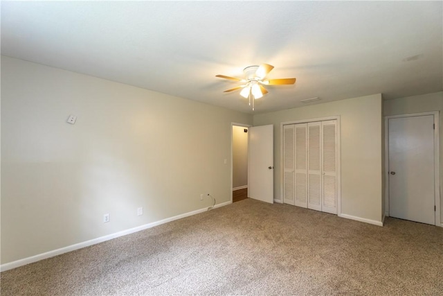 907 Euclid Ave, Waycross, GA 31501 - unfurnished bedroom featuring carpet, a closet, and ceiling fan