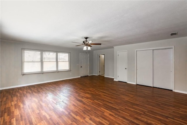907 Euclid Ave, Waycross, GA 31501 - unfurnished bedroom featuring multiple closets, wood finished floors, and ceiling fan