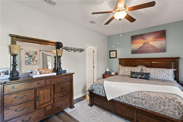 bedroom featuring wood finished floors, baseboards, and ceiling fan