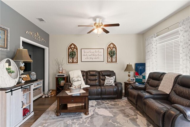 living area featuring ceiling fan and wood finished floors