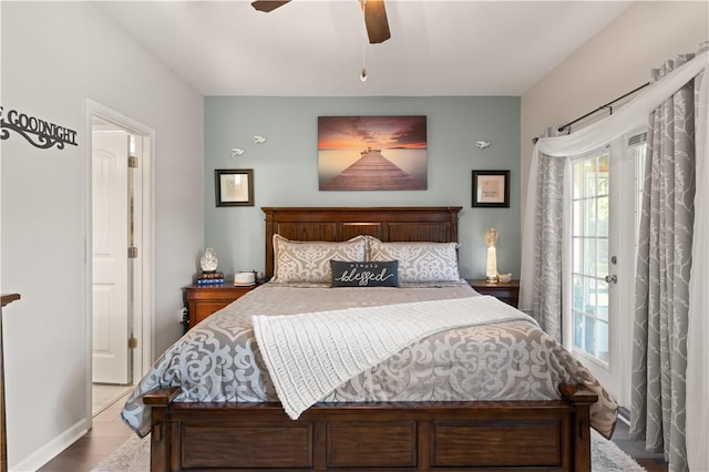 bedroom featuring ceiling fan, wood finished floors, and baseboards