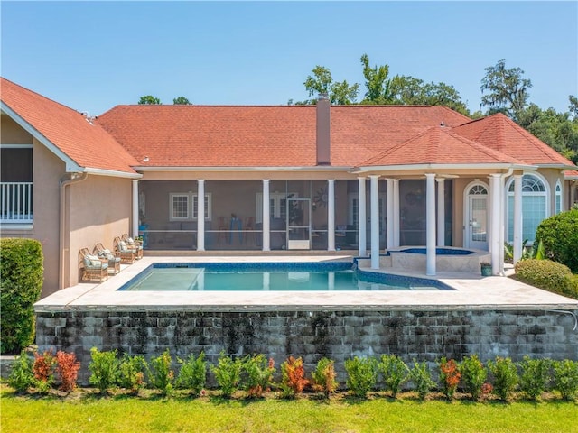 95 Laurel Grove Rd, Brunswick, GA 31523 - back of house featuring a hot tub, a sunroom, stucco siding, an outdoor pool, and a patio area