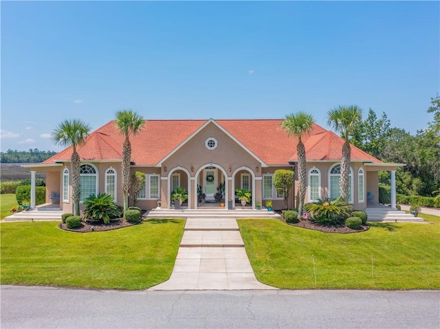95 Laurel Grove Rd, Brunswick, GA 31523 - mediterranean / spanish home with covered porch, stucco siding, and a front yard