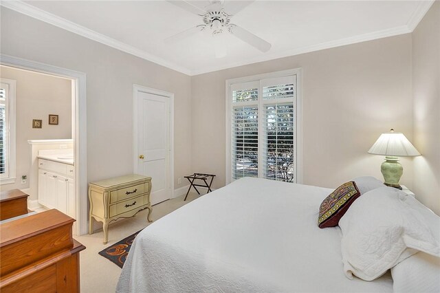 bedroom featuring light carpet, connected bathroom, ceiling fan, and crown molding