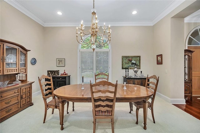 carpeted dining space featuring a notable chandelier and ornamental molding