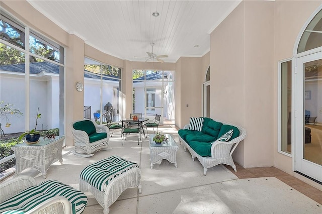 sunroom / solarium with ceiling fan and a healthy amount of sunlight