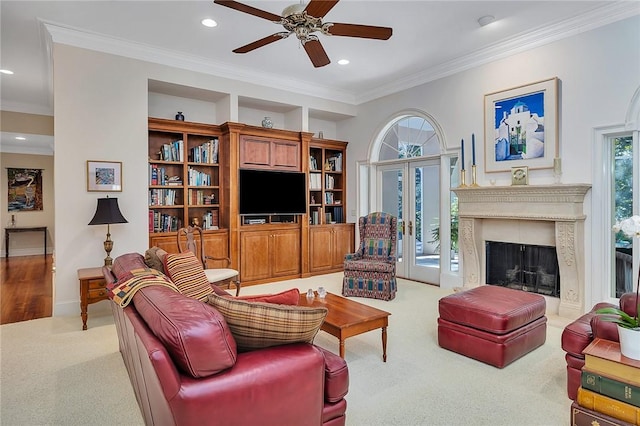 carpeted living room featuring ceiling fan and ornamental molding