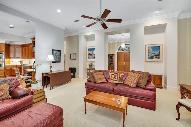 living room featuring light carpet, ceiling fan, and ornamental molding