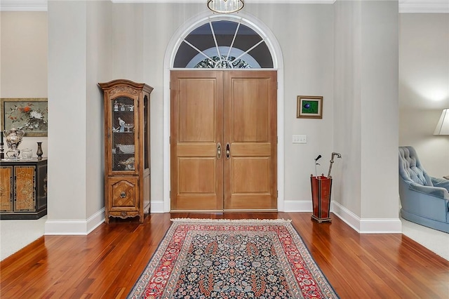 entryway featuring dark hardwood / wood-style flooring and crown molding