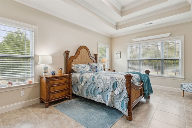 bedroom featuring crown molding, a tray ceiling, and light tile patterned floors