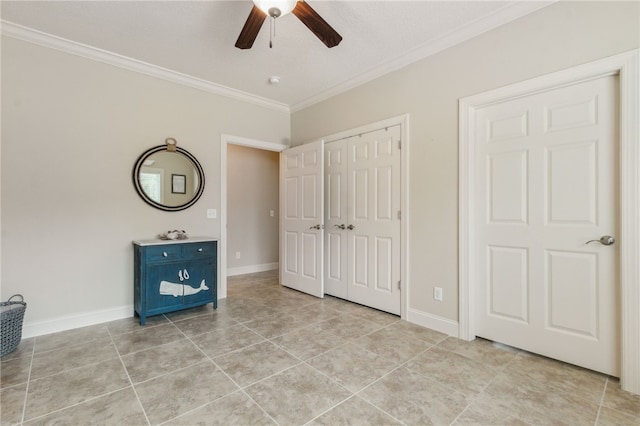 unfurnished bedroom featuring ornamental molding, light tile patterned floors, ceiling fan, and a closet