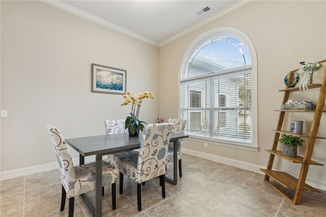 dining room with ornamental molding and light tile patterned flooring