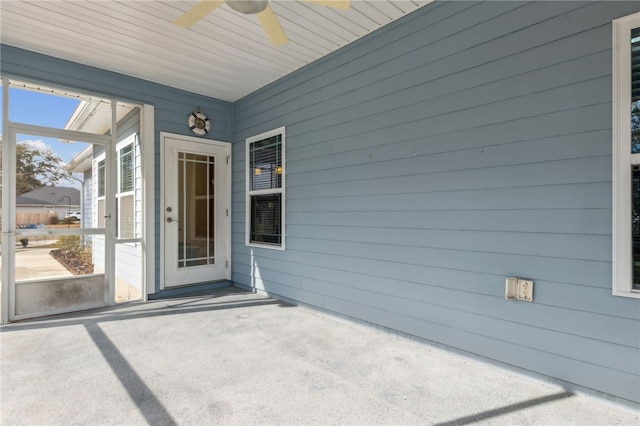 doorway to property with a patio and ceiling fan