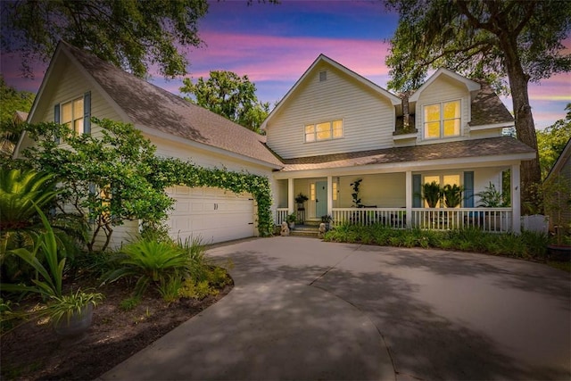 107 Newfield St, Saint Simons Island, GA 31522 - view of front of house with covered porch, concrete driveway, an attached garage, and roof with shingles