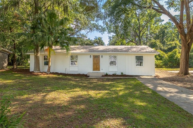 515 Nottingham Dr, Brunswick, GA 31525 - ranch-style home featuring a front yard, brick siding, entry steps, and board and batten siding