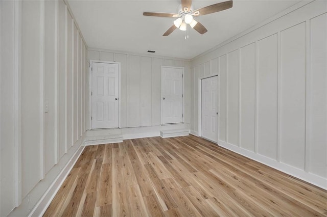 515 Nottingham Dr, Brunswick, GA 31525 - unfurnished bedroom with a decorative wall, light wood-type flooring, and ceiling fan