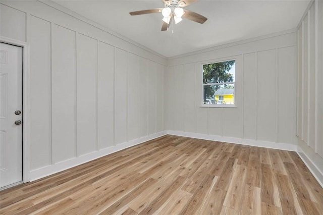 515 Nottingham Dr, Brunswick, GA 31525 - empty room featuring a decorative wall, light wood-style floors, a ceiling fan, and ornamental molding