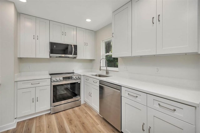 515 Nottingham Dr, Brunswick, GA 31525 - kitchen with appliances with stainless steel finishes, white cabinetry, light countertops, and recessed lighting