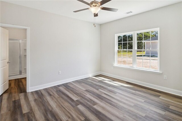 unfurnished room featuring ceiling fan and dark wood-type flooring