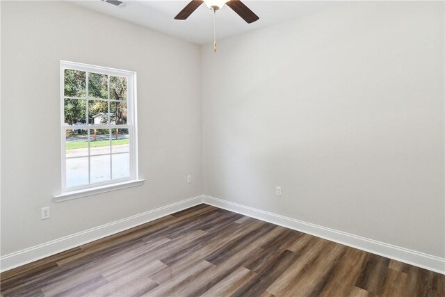 unfurnished room with ceiling fan and dark hardwood / wood-style flooring