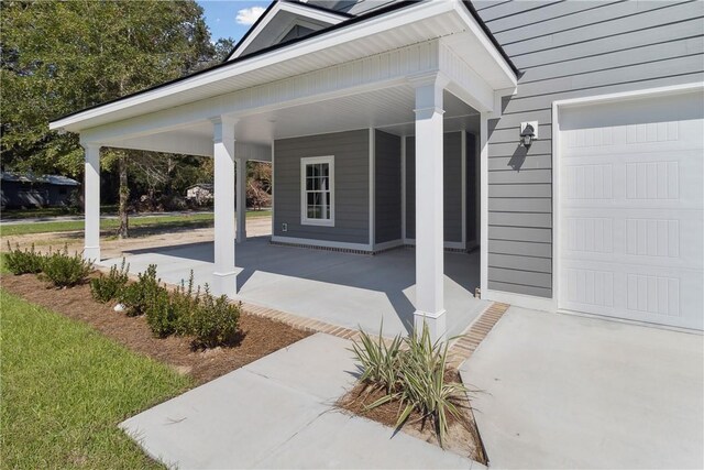 view of exterior entry with covered porch