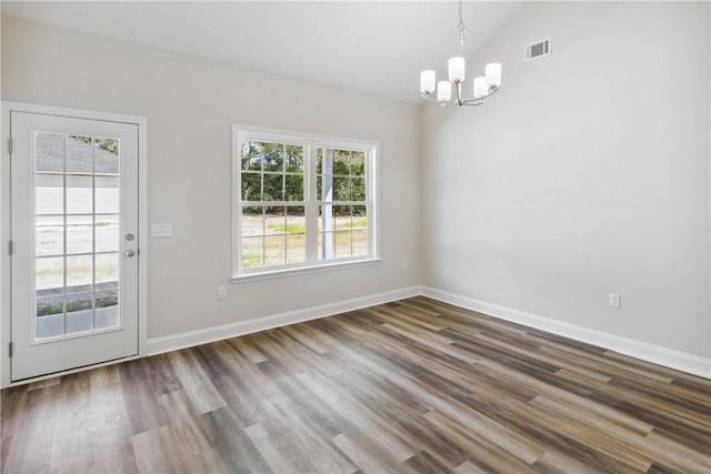 unfurnished dining area featuring a chandelier, a wealth of natural light, and dark wood-type flooring