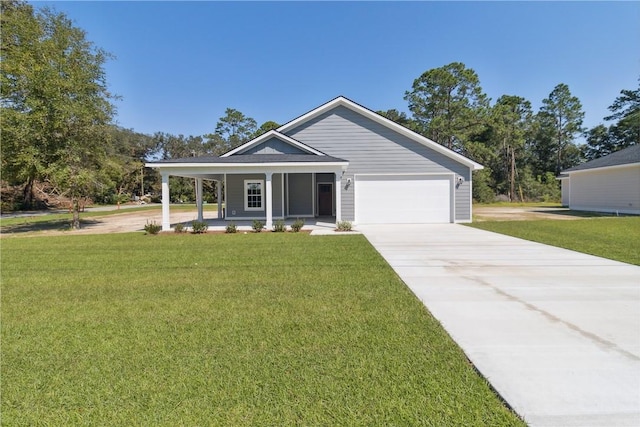 view of front of house with covered porch, a front yard, and a garage