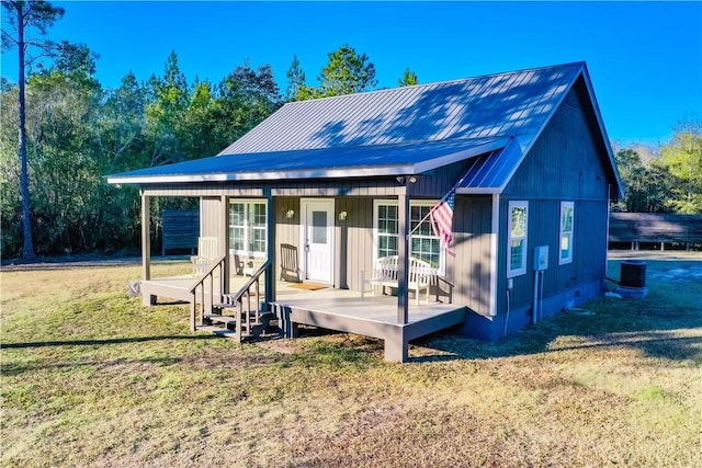 exterior space with central AC unit and a yard