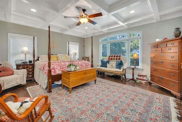 bedroom featuring dark hardwood / wood-style flooring, coffered ceiling, ceiling fan, crown molding, and beam ceiling