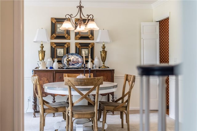 dining space with carpet floors, ornamental molding, and an inviting chandelier
