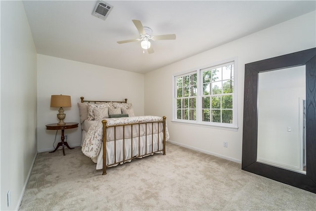 carpeted bedroom featuring baseboards, a ceiling fan, and visible vents