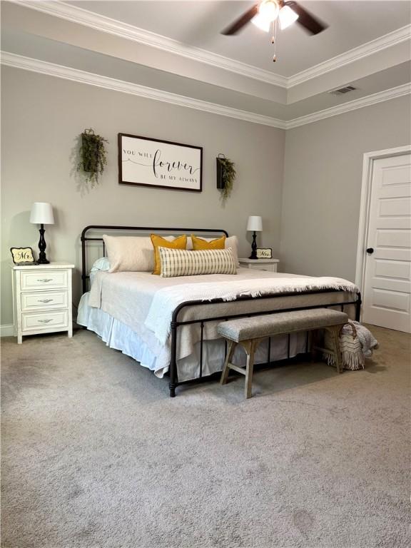 carpeted bedroom with a ceiling fan, visible vents, and ornamental molding