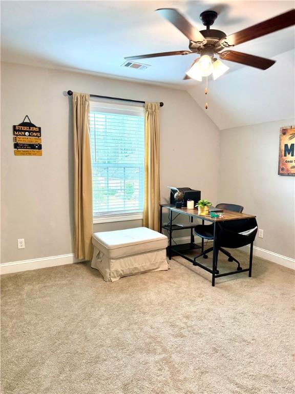 interior space featuring light carpet, visible vents, baseboards, and lofted ceiling