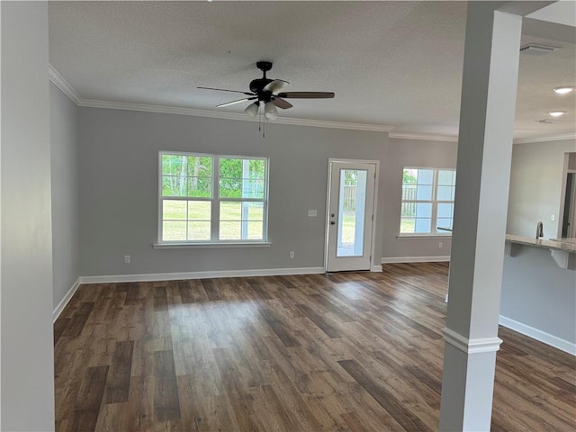 100 Haven Ct, Brunswick, GA 31523 - unfurnished living room featuring a ceiling fan, dark wood-type flooring, crown molding, baseboards, and a textured ceiling