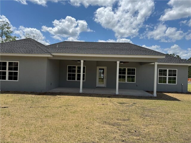 100 Haven Ct, Brunswick, GA 31523 - back of house featuring stucco siding, a patio, a yard, and a ceiling fan