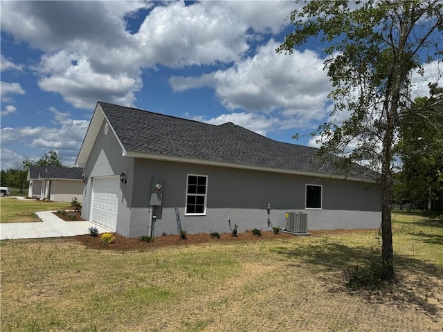 100 Haven Ct, Brunswick, GA 31523 - view of side of home with central AC, a garage, stucco siding, a lawn, and concrete driveway