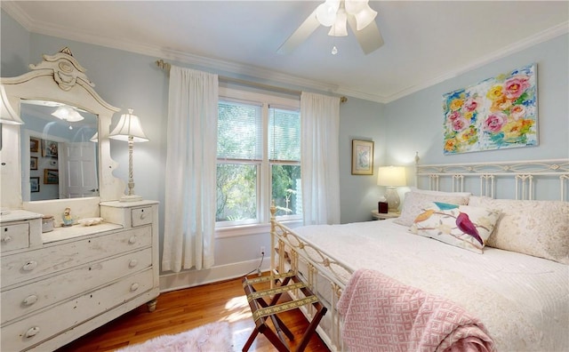231 Magnolia Ave, Saint Simons Island, GA 31522 - bedroom featuring wood finished floors, crown molding, baseboards, and a ceiling fan