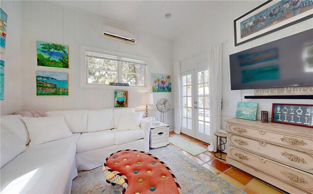 231 Magnolia Ave, Saint Simons Island, GA 31522 - tiled living room with a wall unit AC and french doors