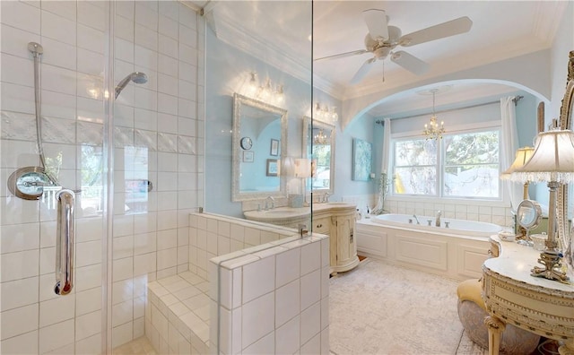 231 Magnolia Ave, Saint Simons Island, GA 31522 - bathroom featuring ornamental molding, a garden tub, tiled shower, vanity, and a ceiling fan