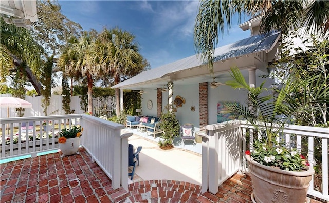 231 Magnolia Ave, Saint Simons Island, GA 31522 - view of patio / terrace with ceiling fan, an outdoor hangout area, and fence
